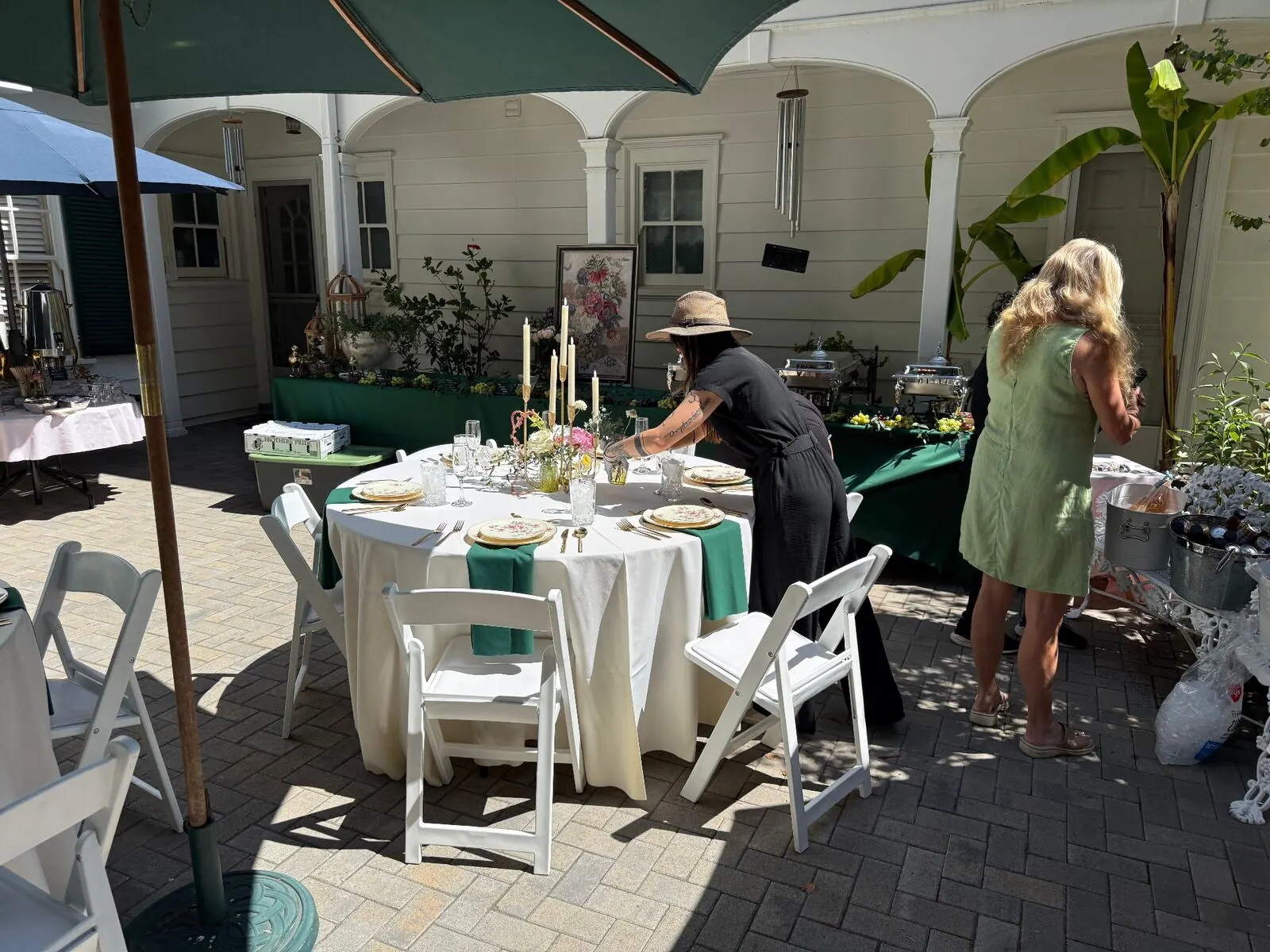 Courtyard event setup with rented tables, linens, and place settings for a San Francisco private party by Winslow's Catering