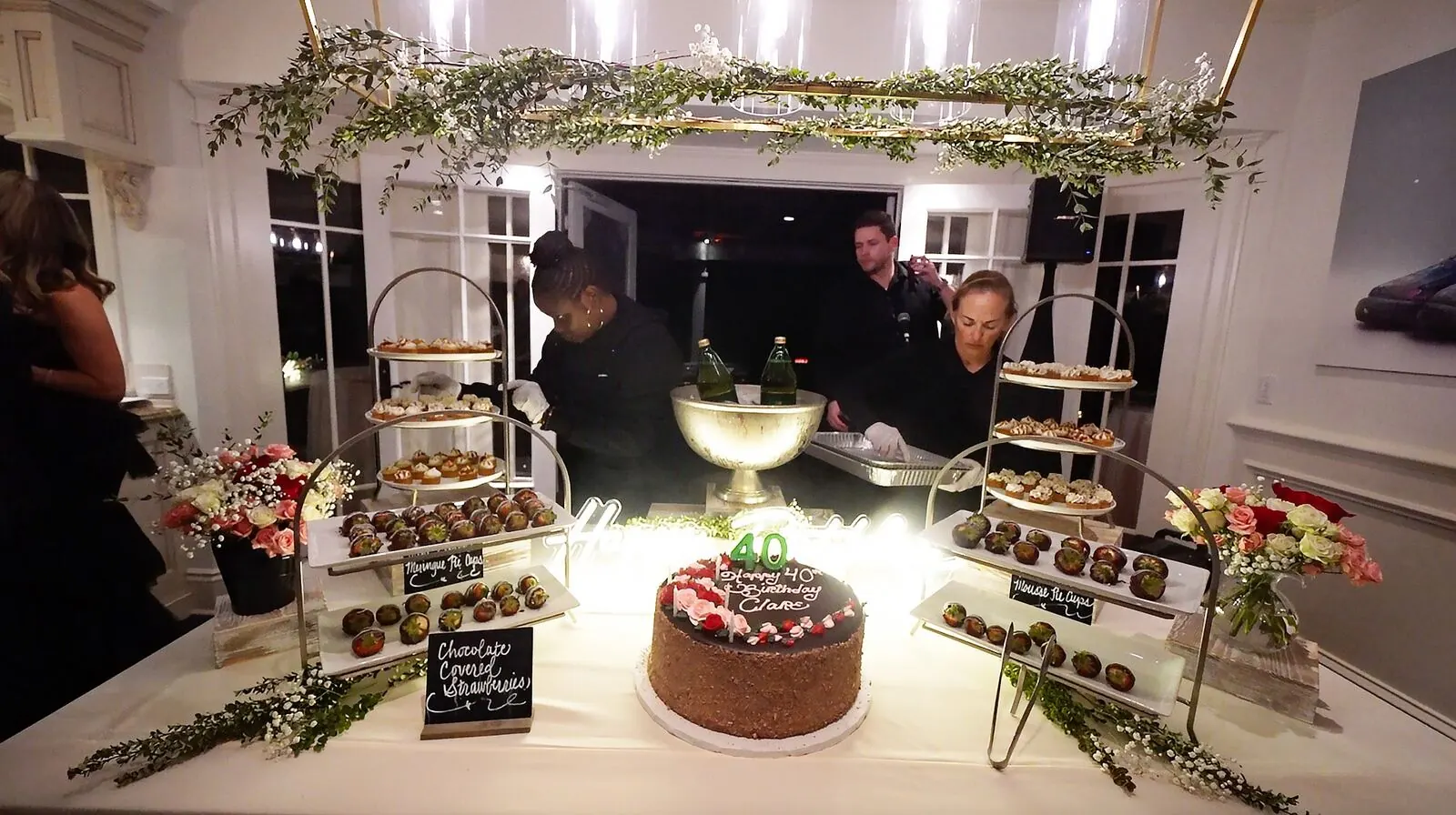 Sweets tablescape of chocolate-shelled berries, a tiered cake and petite treats over layered cloth