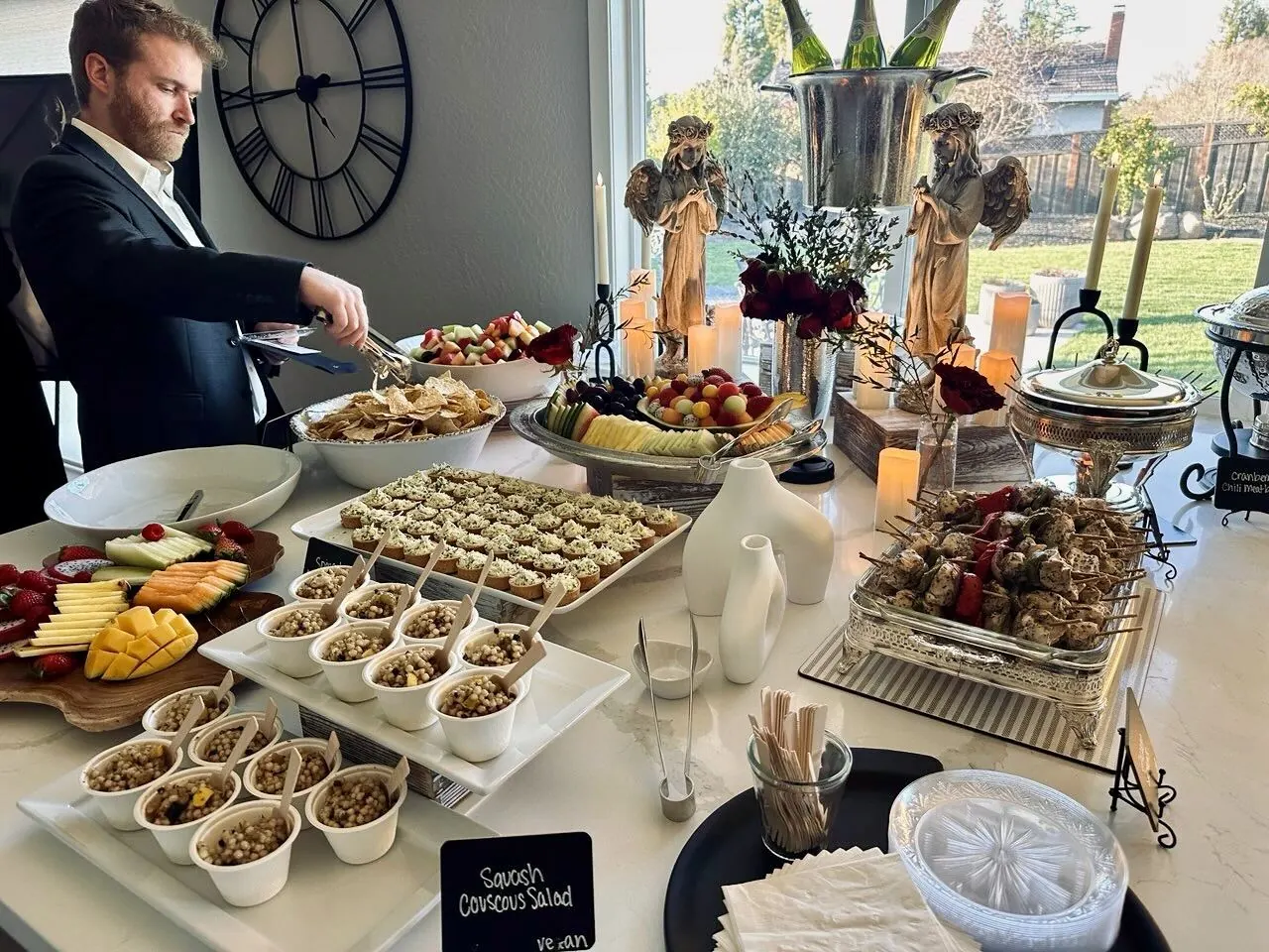 Elegant linened buffet with hot entrees, salads, and platters set for a downtown San Francisco reception by Winslow's Catering