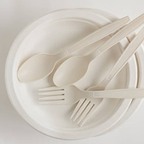 White empty plate with forks and spoons