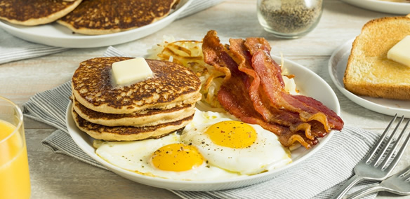 Breakfast catering with eggs, pancakes, bacon, and hash browns