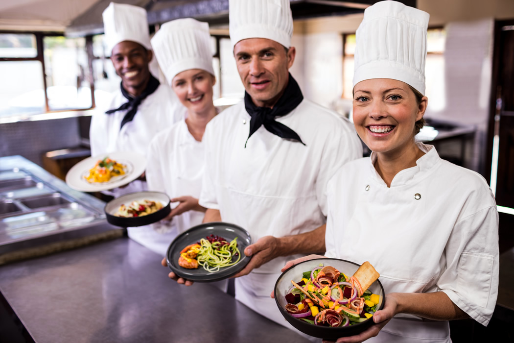 Winslow's Waiters and Waitresses holding the bowls of delicious food catering